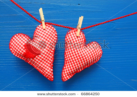 Miłość - stock-photo-two-homemade-sewn-hearts-hanging-on-a-line-against-a-blue-wall-66864250.jpg